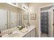 Well-lit bathroom features a double sink vanity and a patterned shower curtain at 3290 Winthrop Ne Cir, Marietta, GA 30067