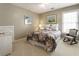 Bright bedroom with floral bedding, rocking chair and white wicker drawers at 3290 Winthrop Ne Cir, Marietta, GA 30067