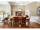 Formal dining room with wainscoting, hardwood floors, and elegant chandelier at 3290 Winthrop Ne Cir, Marietta, GA 30067