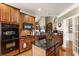 Well-appointed kitchen with dark cabinets, black granite, and a kitchen island at 3290 Winthrop Ne Cir, Marietta, GA 30067