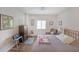Bedroom with natural light from one window, cozy chair, hardwood floors, and comfortable furniture at 1800 Clairmont Lk # 427, Decatur, GA 30033