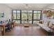Inviting sitting area with a large window offering views of mature trees and a comfortable couch with decorative pillows at 1800 Clairmont Lk # 427, Decatur, GA 30033