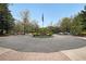 Circular driveway with central flower bed and American flag, leading to the property's entrance at 1800 Clairmont Lk # A427, Decatur, GA 30033