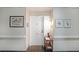 Welcoming hallway with neutral walls, decorative art, and a convenient table, creating a warm entry space at 1800 Clairmont Lk # A427, Decatur, GA 30033