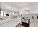 Bright kitchen featuring white cabinetry, laminate countertops and efficient layout, perfect for meal preparation and cooking at 1800 Clairmont Lk # A427, Decatur, GA 30033
