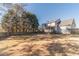 View of the house and backyard with a fire pit surrounded by a wooden fence at 241 Rockingham Dr, Loganville, GA 30052