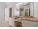 Large bathroom includes a double sink vanity, granite counters, and tile floor at 241 Rockingham Dr, Loganville, GA 30052