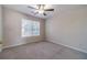 Carpeted bedroom with a ceiling fan and a window with blinds at 241 Rockingham Dr, Loganville, GA 30052