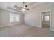 Spacious bedroom features a tray ceiling with ceiling fan and large window at 241 Rockingham Dr, Loganville, GA 30052