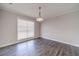 Dining room with wood-look floors, chair rail, and light fixture at 241 Rockingham Dr, Loganville, GA 30052