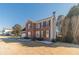 Two-story brick house with a manicured lawn, flower beds, and mature trees at 241 Rockingham Dr, Loganville, GA 30052