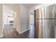 View of the kitchen through the doorway, showing stainless steel appliances and view to living room at 241 Rockingham Dr, Loganville, GA 30052