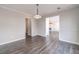 Open-concept floor plan with wood-look floors showcasing the dining room, and living room with fireplace at 241 Rockingham Dr, Loganville, GA 30052
