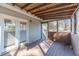 View of the sunroom with wood floors, walls and ceiling and backyard access at 241 Rockingham Dr, Loganville, GA 30052