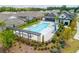 Aerial view of a community pool and clubhouse area, featuring plenty of lounge seating and landscaping at 437 Great Pine Way, Woodstock, GA 30188