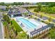 Aerial view of a community pool and clubhouse with lounge chairs and umbrellas at 437 Great Pine Way, Woodstock, GA 30188