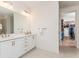 Modern bathroom with dual sink vanity and quartz countertop near the walk-in closet at 437 Great Pine Way, Woodstock, GA 30188