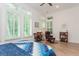 Inviting bedroom with plantation shutters, wood floors, ceiling fan and sitting area at 437 Great Pine Way, Woodstock, GA 30188