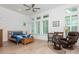 Bright bedroom features a ceiling fan, wood floors, plantation shutters and sitting area at 437 Great Pine Way, Woodstock, GA 30188