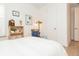 Bright bedroom with white walls, wood floors, with door access to the bathroom at 437 Great Pine Way, Woodstock, GA 30188