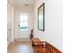 Light and airy entryway with beautiful hardwood floors, natural light, and a decorative bench at 437 Great Pine Way, Woodstock, GA 30188