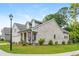Beautiful exterior brick home featuring dormers, a landscaped yard, and sidewalk access at 437 Great Pine Way, Woodstock, GA 30188