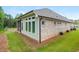 Exterior view of a brick home with a screened porch and a well-maintained lawn at 437 Great Pine Way, Woodstock, GA 30188