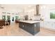 Open-concept kitchen featuring a large island, stainless steel appliances, and hardwood floors at 437 Great Pine Way, Woodstock, GA 30188
