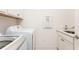 Functional laundry room with a Samsung washer and dryer next to a utility sink at 437 Great Pine Way, Woodstock, GA 30188