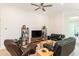 Cozy living room with hardwood floors, ceiling fan, and comfortable seating arrangement at 437 Great Pine Way, Woodstock, GA 30188