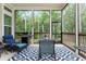 Screened-in porch featuring a table, chairs, grill, and an outdoor area with views at 437 Great Pine Way, Woodstock, GA 30188