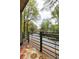 Balcony featuring views of the street, a green metal railing, and a colorful patterned rug at 67 25Th Nw St # 5, Atlanta, GA 30309