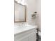 Bright bathroom features a white marble vanity, updated faucet, large mirror, and floating shelves with decorative accents at 67 25Th Nw St # 5, Atlanta, GA 30309