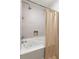 Bright bathroom featuring tiled walls, shower head, and modern bathtub with jacuzzi jets at 67 25Th Nw St # 5, Atlanta, GA 30309