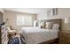 Bright bedroom with wood floors, large window, and a cozy bed with decorative pillows next to a matching nightstand at 67 25Th Nw St # 5, Atlanta, GA 30309