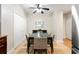 Traditional dining room features a ceiling fan, hardwood floors, neutral walls and a black wood table with beige fabric chairs at 67 25Th Nw St # 5, Atlanta, GA 30309