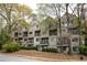 Multi-story condo building with balconies, surrounded by mature trees and landscaping at 67 25Th Nw St # 5, Atlanta, GA 30309