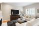 Cozy living room featuring a plush sofa, stylish decor, and a bright window at 67 25Th Nw St # 5, Atlanta, GA 30309