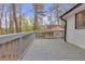 Side view of a wooden deck overlooking backyard with trees and other houses at 1143 Cedar Log, Austell, GA 30168