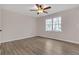 Bright bedroom features stylish wood flooring, a ceiling fan, and a large window for ample natural light at 1143 Cedar Log, Austell, GA 30168