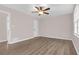 Well-lit bedroom featuring wood floors, a ceiling fan, and a closet, offering comfort and practical storage at 1143 Cedar Log, Austell, GA 30168