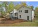 Back exterior view of the house features a wooden deck and a spacious backyard at 1143 Cedar Log, Austell, GA 30168