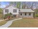 Charming split level home featuring stone accents, covered entry porch, and well-maintained front yard at 1143 Cedar Log, Austell, GA 30168
