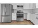 Modern kitchen featuring stainless steel appliances, white cabinets, marble countertops, and hardwood flooring at 1143 Cedar Log, Austell, GA 30168