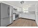 Modern kitchen featuring stainless steel appliances, white cabinets, marble countertops, and hardwood flooring at 1143 Cedar Log, Austell, GA 30168