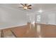 Inviting living room features hardwood floors, a ceiling fan, a fireplace, and easy access to other rooms at 1143 Cedar Log, Austell, GA 30168