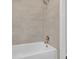Tiled shower over tub features clean lines, modern fixtures, and bright neutral colors at 1143 Cedar Log, Austell, GA 30168