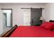 Bedroom showcasing a barn door and view into the Primary bathroom at 1486 Akridge Nw St, Atlanta, GA 30314