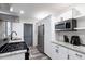 Galley kitchen features stainless appliances, granite counters, and grey accents at 1486 Akridge Nw St, Atlanta, GA 30314