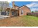 Outdoor view of the home with a covered patio and fenced yard at 226 Double Gate Ct, Sugar Hill, GA 30518